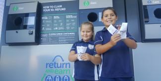Cassidy and Noah Langdon at the reverse vending machines in High Street Wauchope